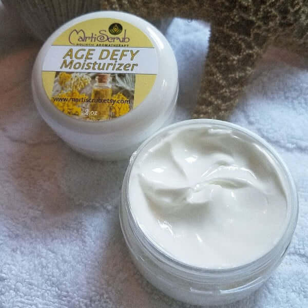 Aromatherapy age-defying moisturizer for mature skin in a white jar on a soft surface.