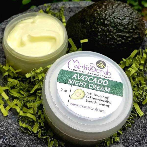 Aromatherapy Avocado Night Cream in a jar with lid, surrounded by green filler and an avocado, highlighting skin nourishment.