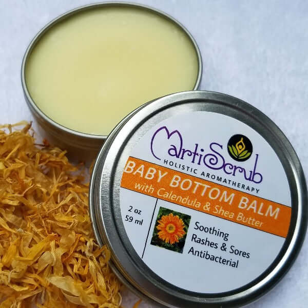 Baby Bottom Balm in a 2 oz tin with Calendula flowers, soothing and antibacterial for sensitive skin.