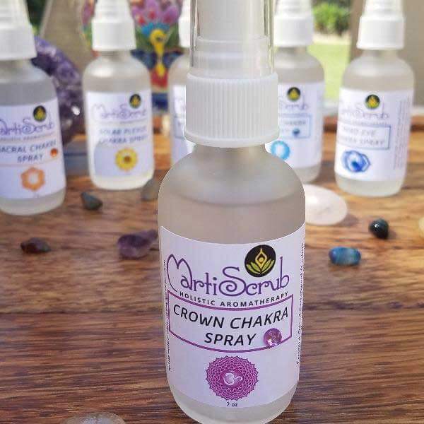 Crown Chakra Spray bottle surrounded by crystal stones, designed for holistic aromatherapy and chakra balancing.