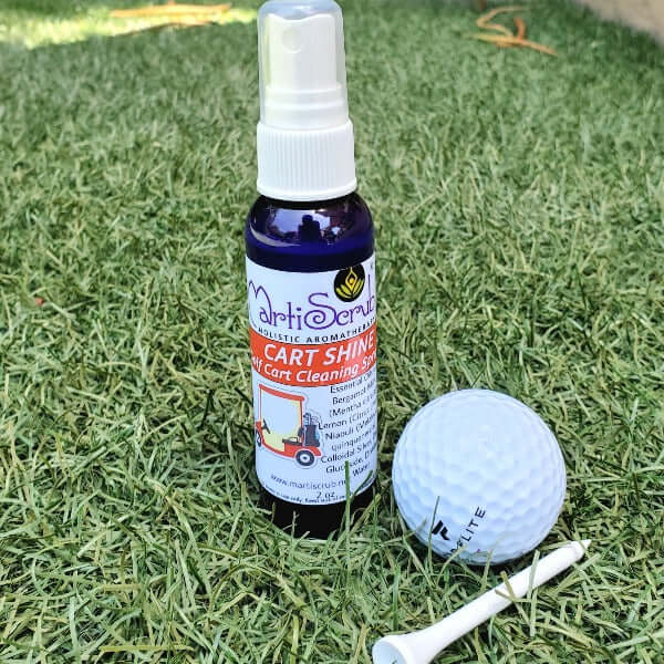 Cart Shine golf cart cleaning spray bottle on grass with a golf ball and tee.