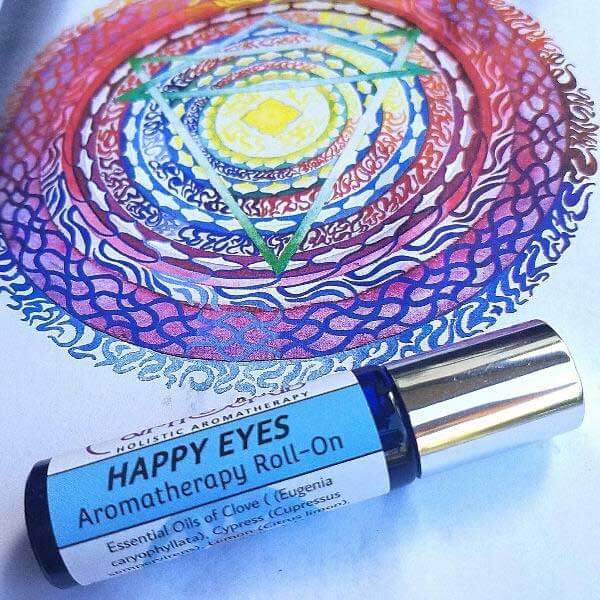 Happy Eyes Essential Oil Roll-On for strained eyes, featuring Clove, Lemon, Cypress, and Frankincense, on colorful background.