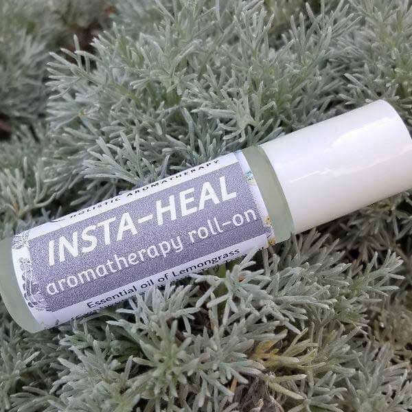 Insta-Heal disinfecting essential oil roll-on with lemongrass on greenery background, 10 ml size.
